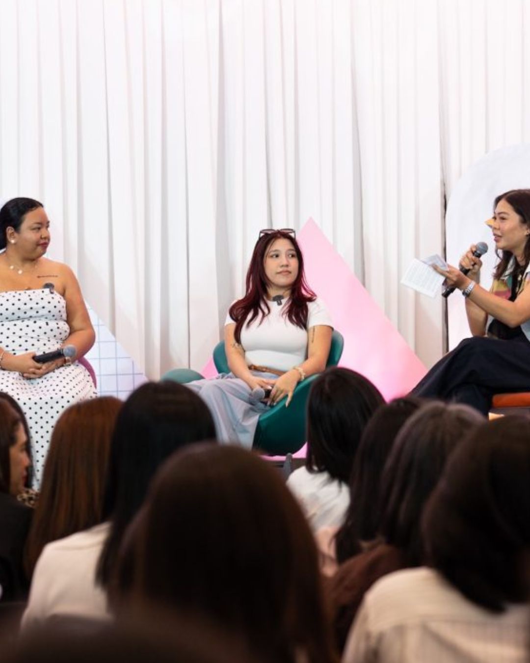 Dana Krystelle speaking on stage at a panel event